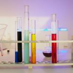 Vibrant test tubes filled with liquids in a modern lab setting, showcasing scientific exploration.
